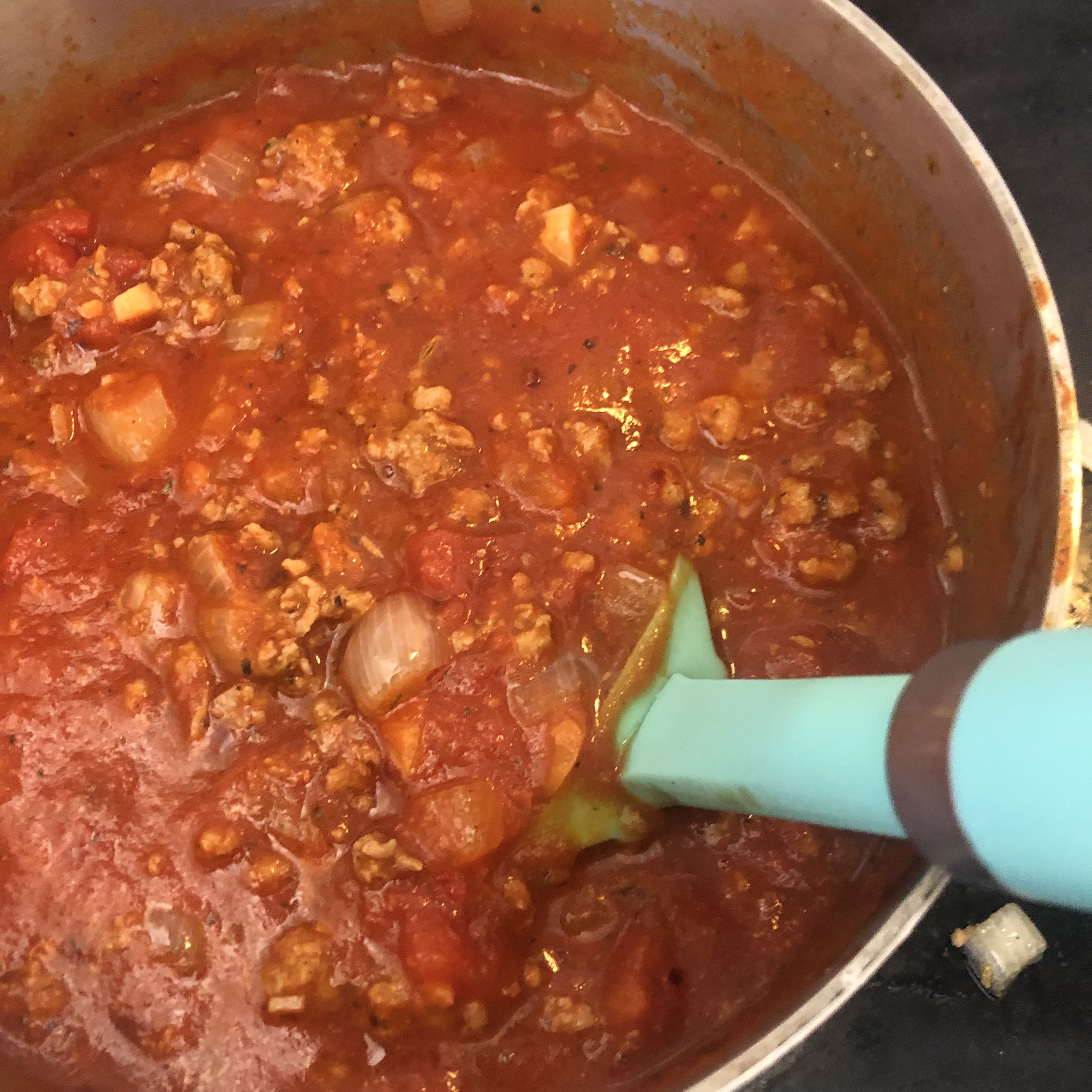 spicy Italian sausage marinara sauce on the stove